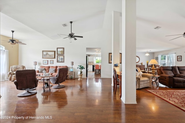 living room featuring dark hardwood / wood-style floors and high vaulted ceiling