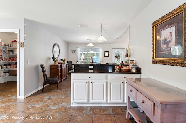 kitchen featuring white cabinetry and pendant lighting