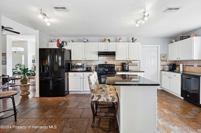 kitchen with white cabinetry, black appliances, a kitchen island, and backsplash