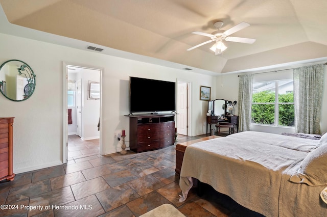 bedroom featuring ceiling fan and a raised ceiling