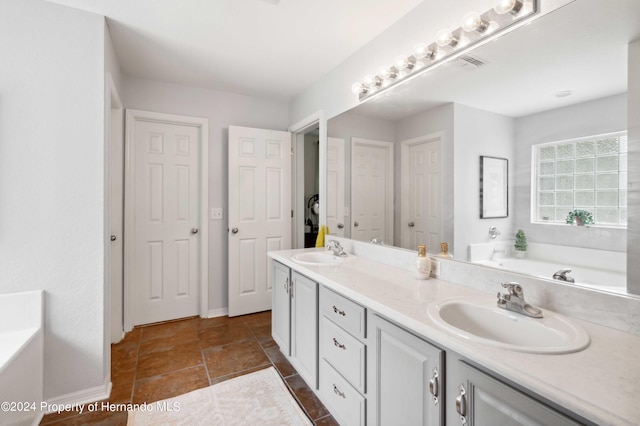 bathroom with vanity and a tub