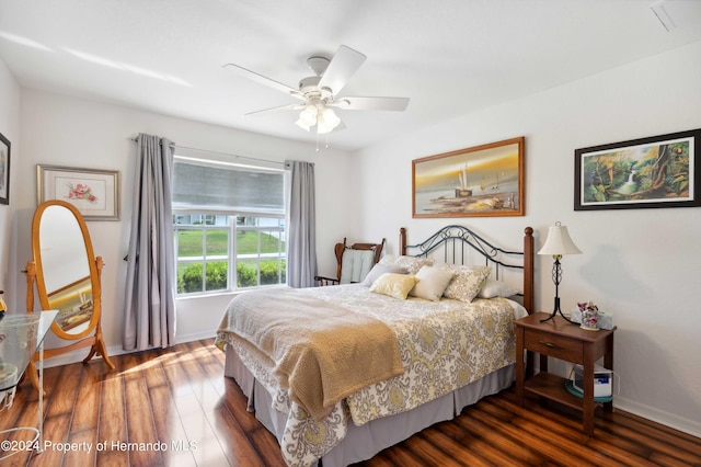 bedroom with dark wood-type flooring and ceiling fan