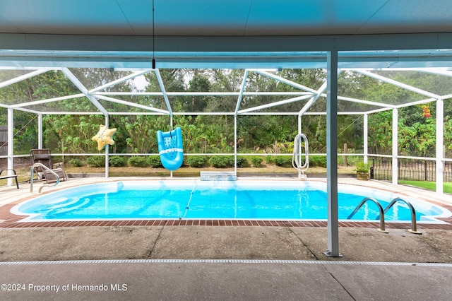 view of pool with a lanai and a patio area