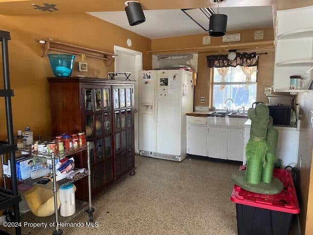 kitchen with sink and white fridge with ice dispenser