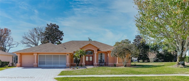 single story home with a garage and a front yard