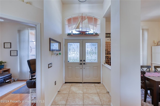 tiled entrance foyer featuring french doors