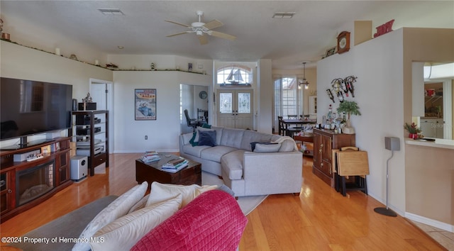 living room featuring french doors, light hardwood / wood-style floors, and ceiling fan