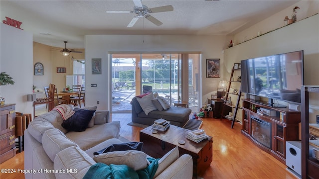 living room featuring light hardwood / wood-style floors and ceiling fan