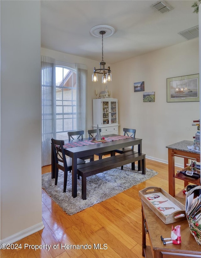 dining area with a chandelier and hardwood / wood-style flooring