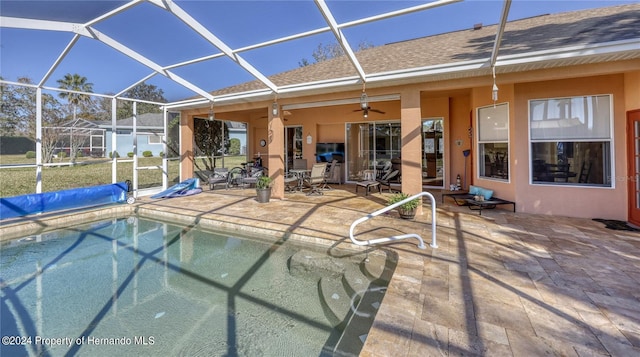 view of swimming pool with a patio area, a lanai, and ceiling fan