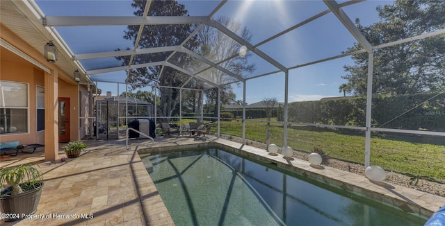 view of swimming pool with a lawn, glass enclosure, and a patio