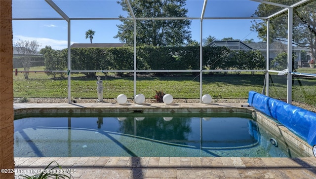 view of pool featuring a lanai and a yard