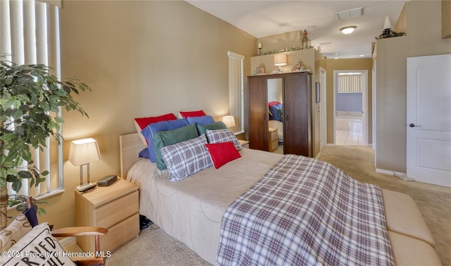 bedroom featuring vaulted ceiling and light colored carpet