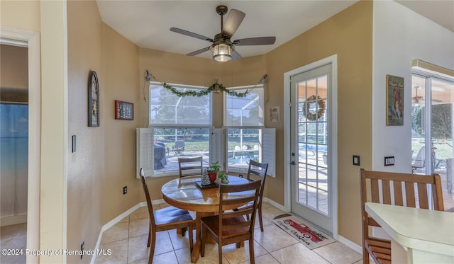 tiled dining area featuring ceiling fan