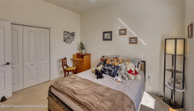 bedroom featuring light colored carpet and a closet