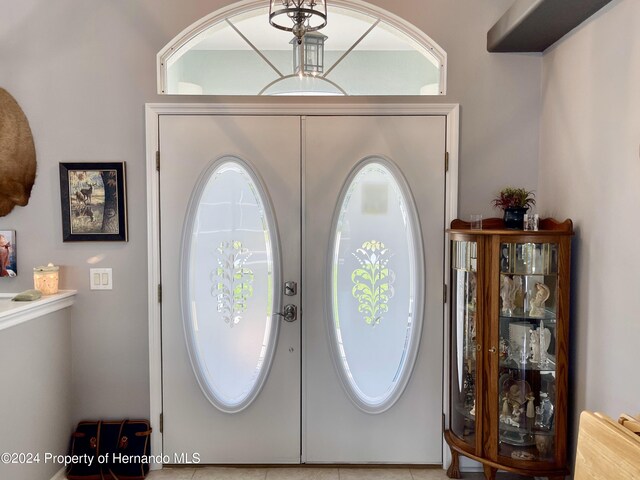 tiled foyer entrance with french doors