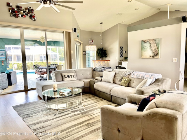 living room featuring hardwood / wood-style flooring, ceiling fan, and lofted ceiling