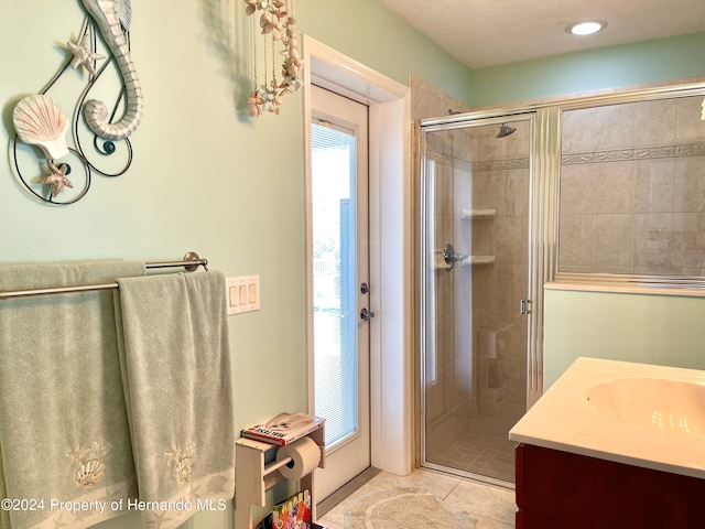 bathroom with vanity, tile patterned floors, and an enclosed shower