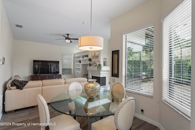 dining space with ceiling fan and dark hardwood / wood-style floors