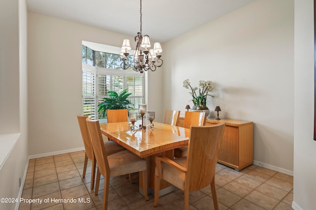 dining space with light tile patterned floors and a notable chandelier