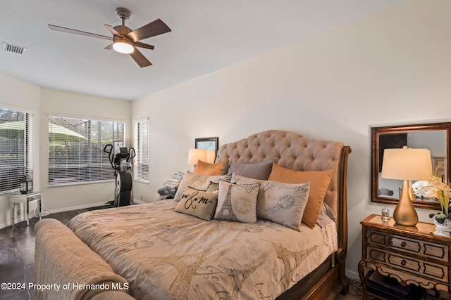 bedroom with ceiling fan and dark hardwood / wood-style floors