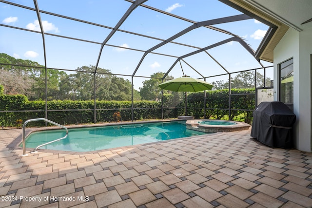 view of pool with a lanai, grilling area, an in ground hot tub, and a patio area