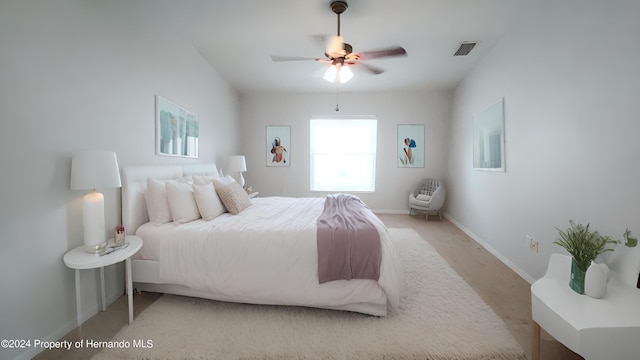 bedroom with light hardwood / wood-style flooring and ceiling fan