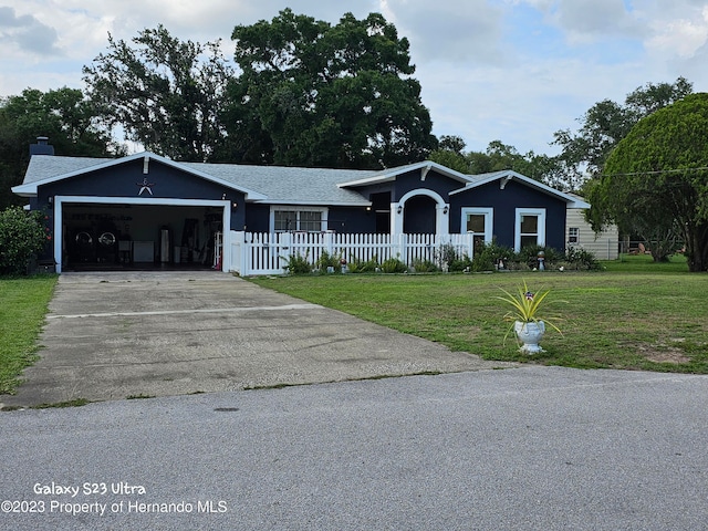 single story home with a garage and a front lawn