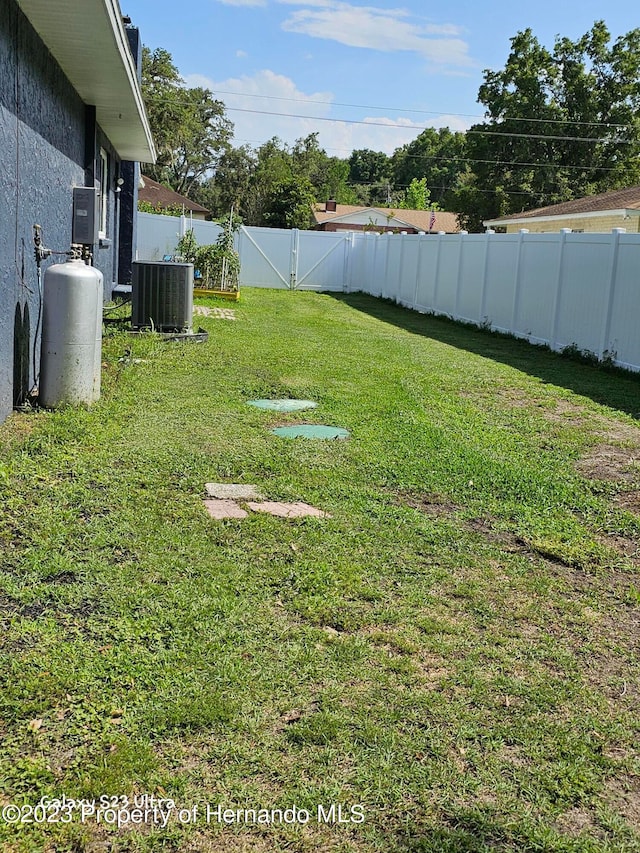 view of yard with central AC unit