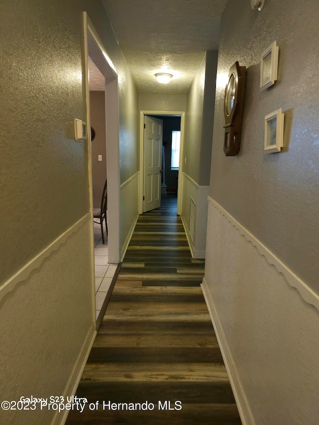 hallway featuring dark hardwood / wood-style flooring