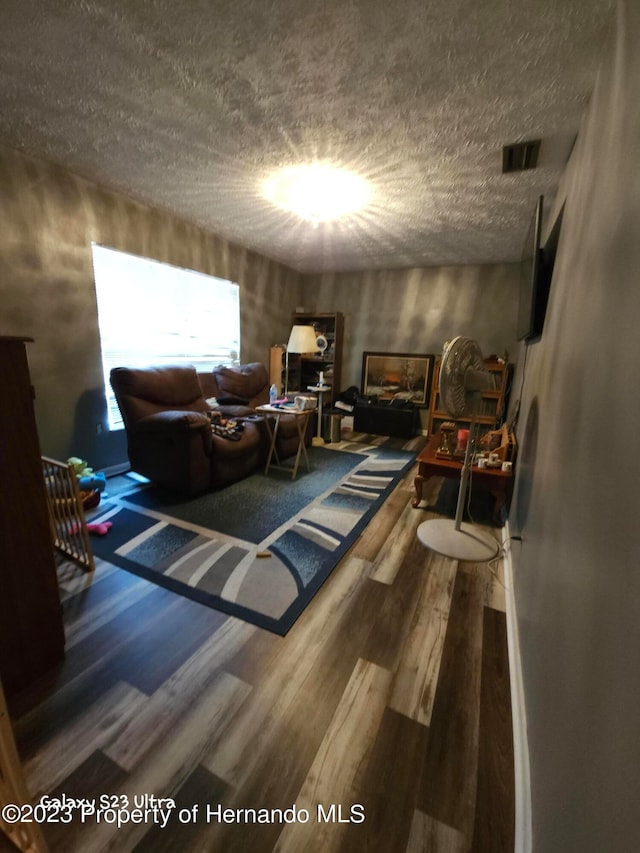 sitting room featuring hardwood / wood-style floors and a textured ceiling