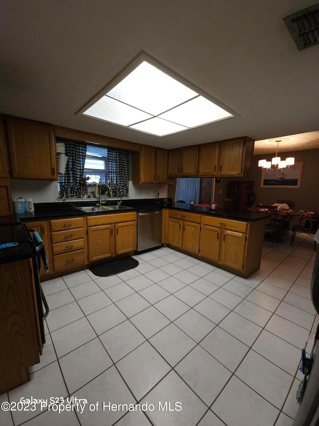 kitchen featuring sink, kitchen peninsula, a chandelier, pendant lighting, and dishwasher