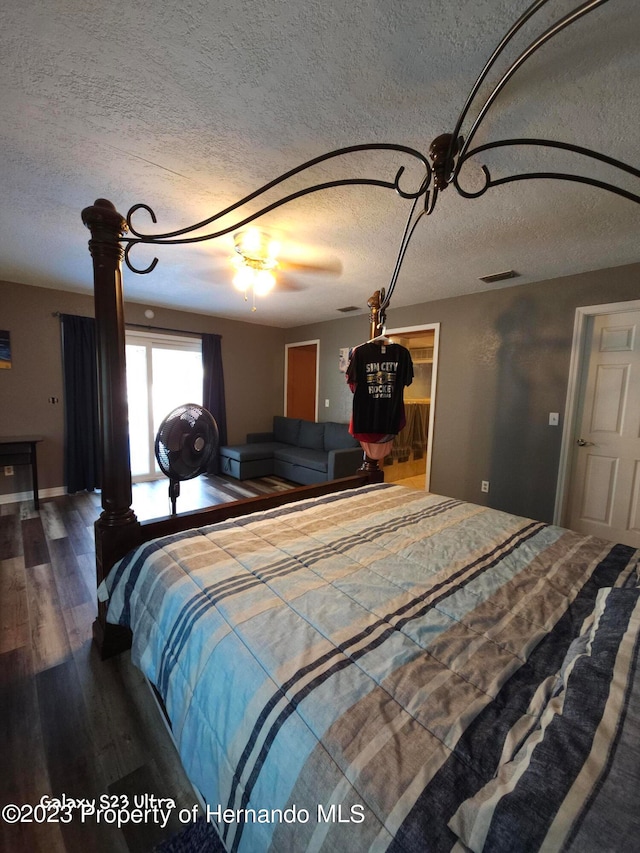 bedroom featuring wood-type flooring and a textured ceiling