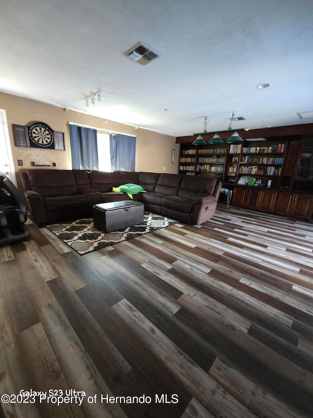 living room featuring a textured ceiling and hardwood / wood-style flooring