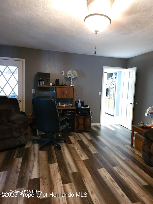 office space with dark hardwood / wood-style flooring and a textured ceiling