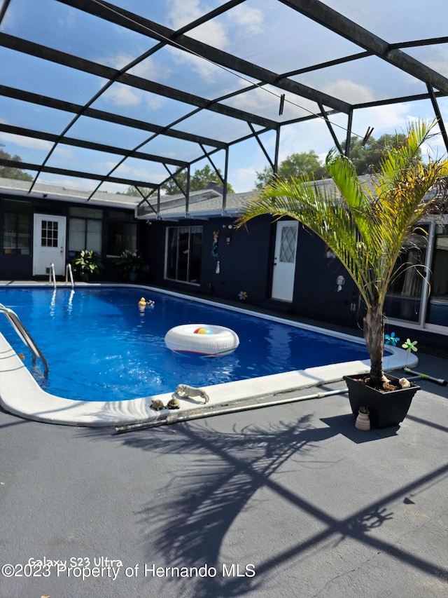 view of pool with a lanai and a patio