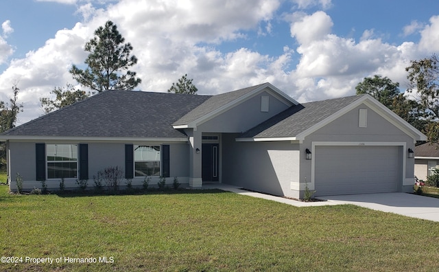 view of front of house featuring a garage and a front lawn