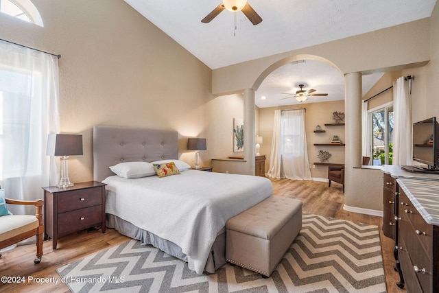 bedroom with light wood-type flooring, lofted ceiling, and ceiling fan