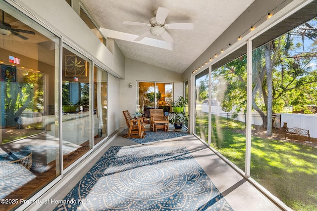 sunroom with lofted ceiling and ceiling fan