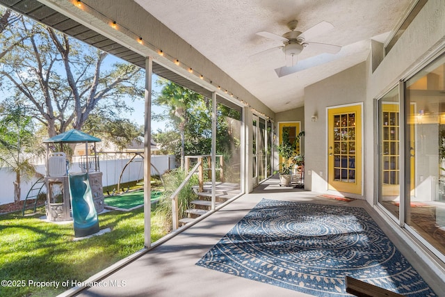 sunroom featuring lofted ceiling and ceiling fan