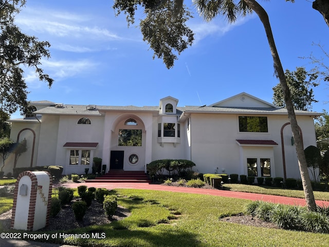 11915 W Riverhaven Dr, Homosassa, FL 34448 - mediterranean / spanish house featuring stucco siding and a front lawn