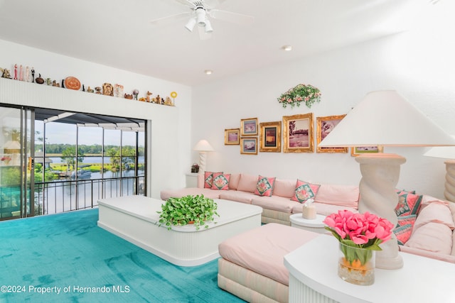 living room featuring a water view, ceiling fan, and carpet floors