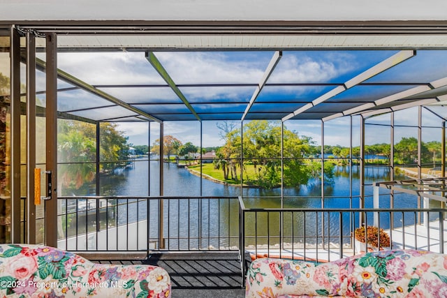 unfurnished sunroom featuring a water view