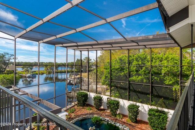 unfurnished sunroom with a water view