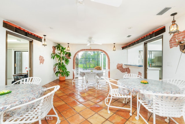 dining space featuring tile patterned flooring and ceiling fan