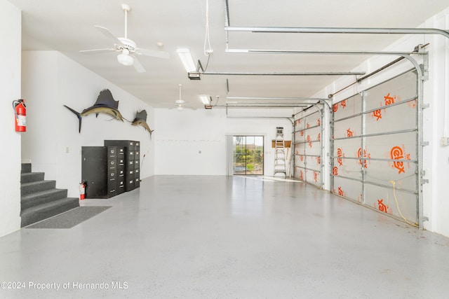 garage featuring ceiling fan and a garage door opener