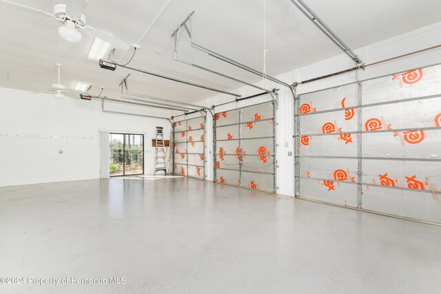 garage featuring a garage door opener and ceiling fan