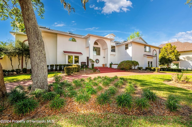 mediterranean / spanish house with a front lawn