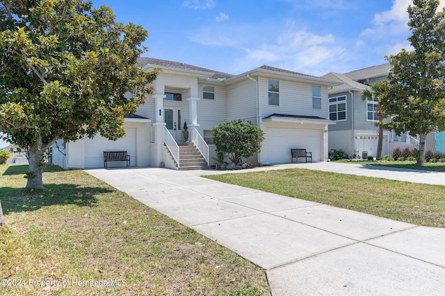 view of front of property with a garage and a front lawn