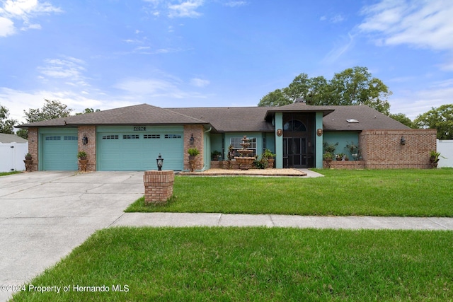 ranch-style home with a garage and a front yard